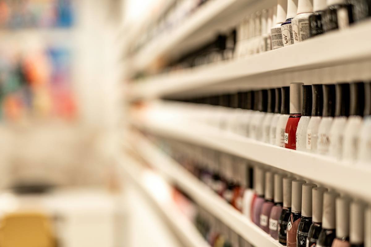 Infographic comparing organized vs chaotic nail polish storage showing time savings, product longevity, and space efficiency metrics