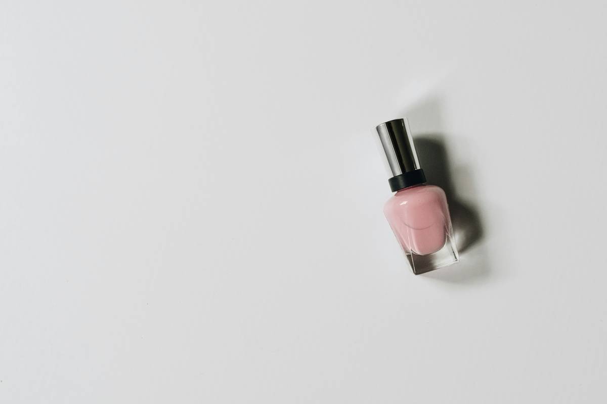 Side-by-side comparison of glass vs. plastic nail polish containers showing oxidation levels after 6 months