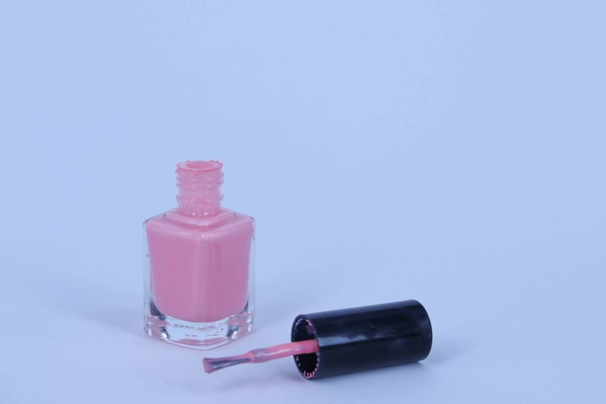 Premium nail paint container with amber glass and natural-bristle brush for long-lasting polish